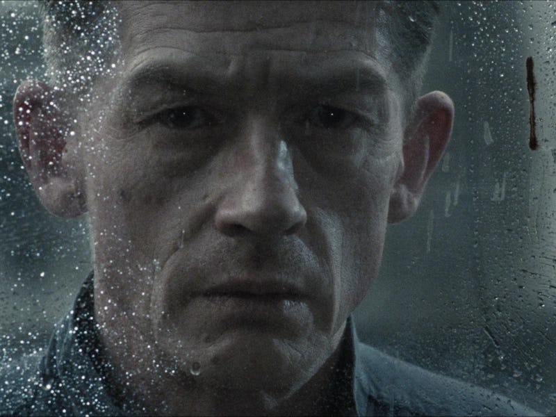 Winston Smith (John Hurt) looks through a rain-soaked window in 1984