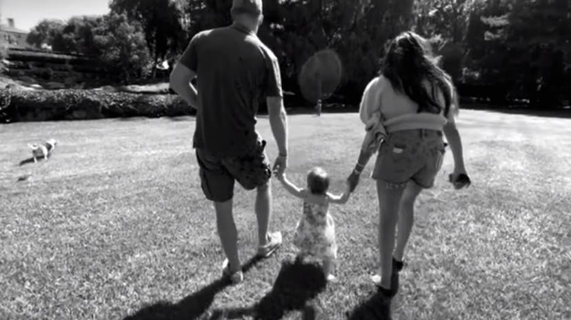 Prince Harry helps daughter Lilibet learn to walk.