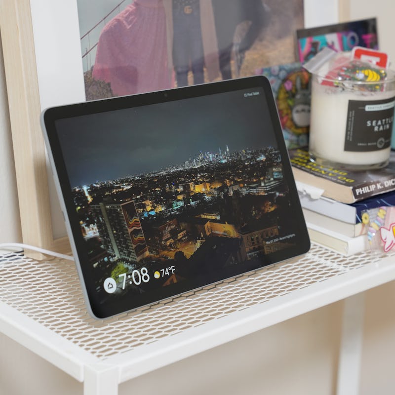 Google Pixel Tablet in Hub Mode sitting on a shelf showing digital pictures from Google Photos