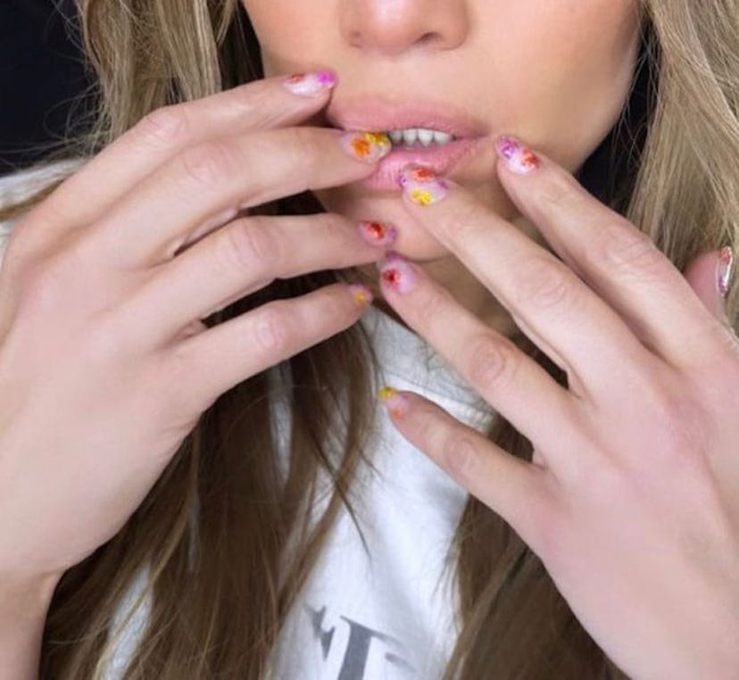 Jennifer Lopez dried flower manicure in red pink and yellow