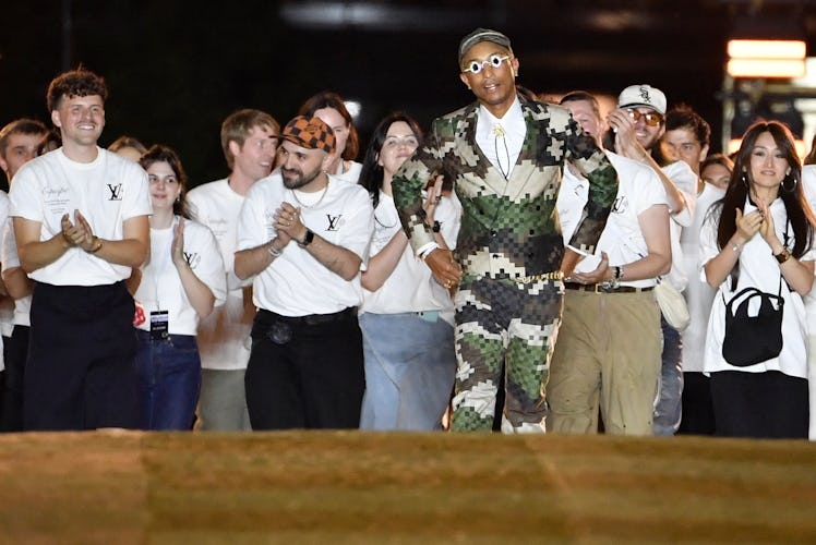 US Louis Vuitton' fashion designer and singer Pharrell Williams acknowledges the audience at the end...