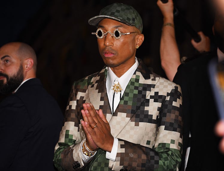US Louis Vuitton' fashion designer and singer Pharrell Williams acknowledges the audience at the end...