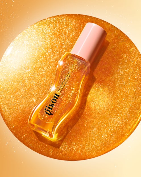 The new Gisou Honey Infused Lip Oil Golden Shimmer Glow, launching on June 20, 2023.