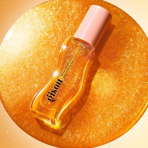 The new Gisou Honey Infused Lip Oil Golden Shimmer Glow, launching on June 20, 2023.