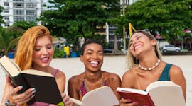 Three friends reading a book during the July 2023 Super Buck Moon.