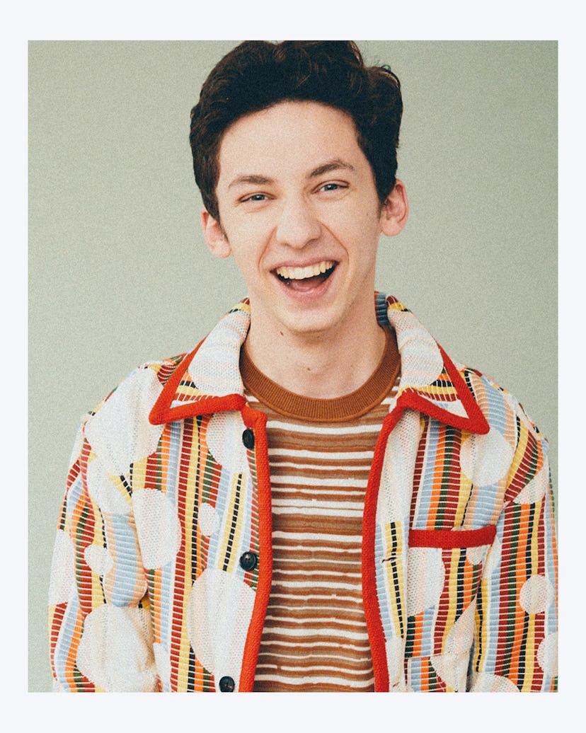 A portrait og Andrew Barth Feldman laughing