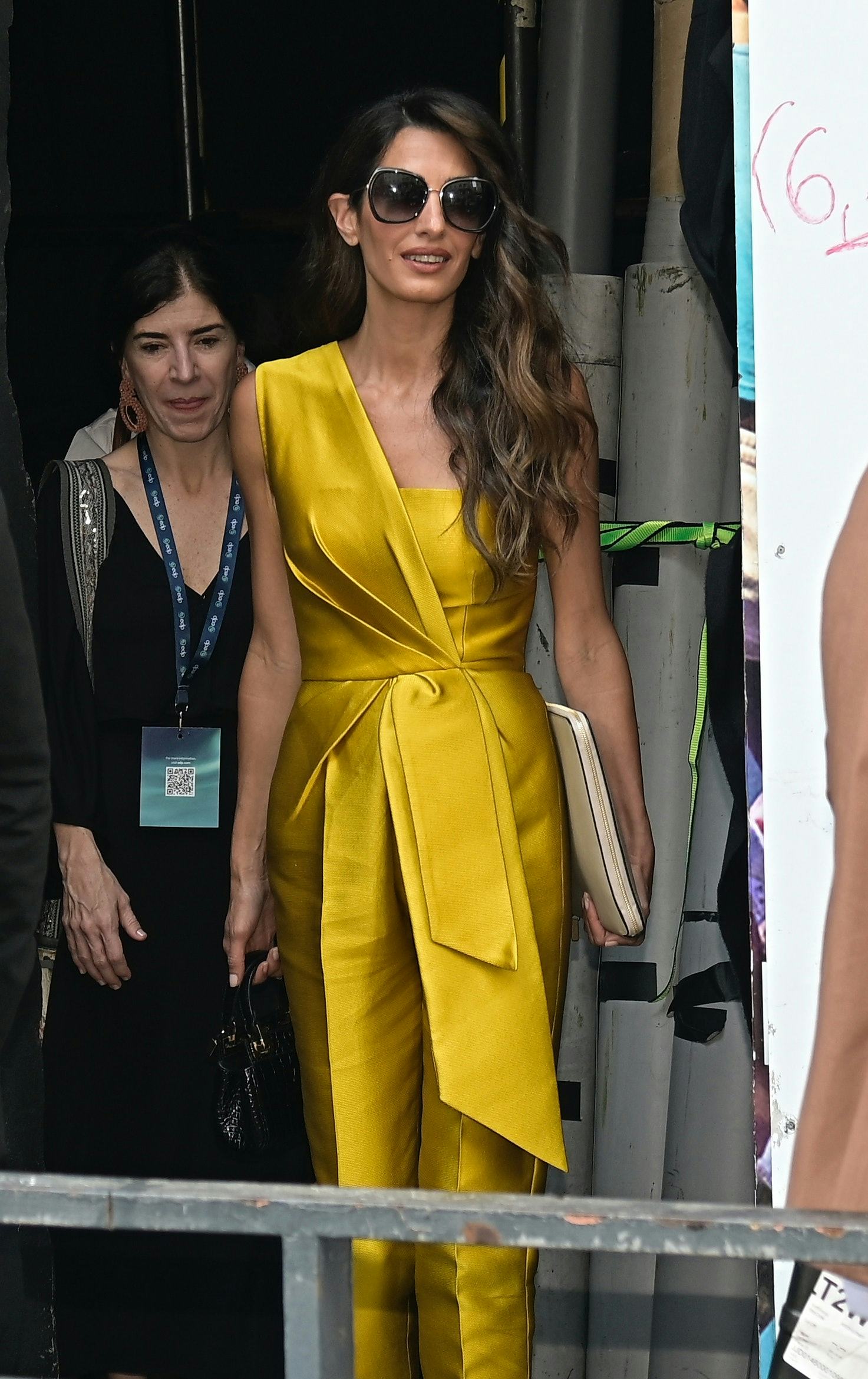 Amal Clooney Shines In a One Shoulder Yellow Satin Jumpsuit In Madrid