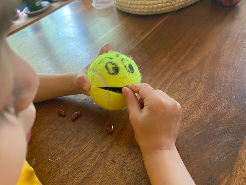 OT activity for toddlers: tennis ball monster and dried beans