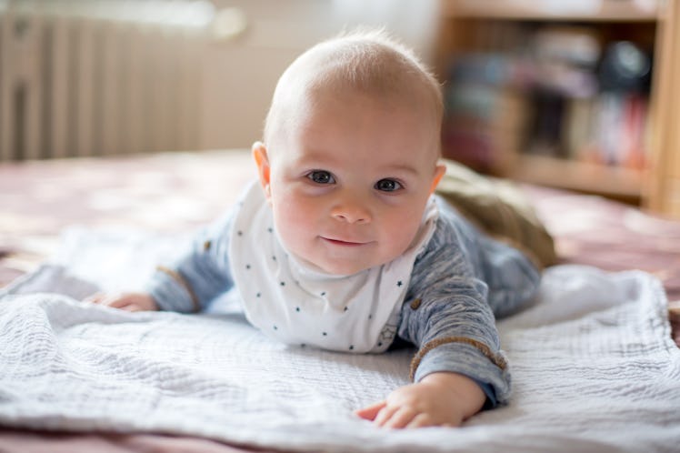 A baby boy on his stomach.