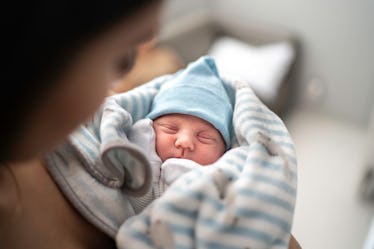 A mom holding her newborn baby boy.