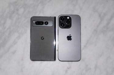 The Pixel Fold next to an iPhone 14 Pro.