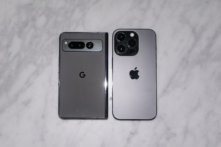 The Pixel Fold next to an iPhone 14 Pro.