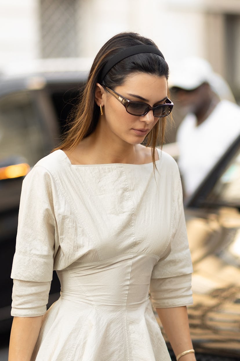 Kendall Jenner wears a white mini dress and Hermes Birkin bag in Paris, France.
