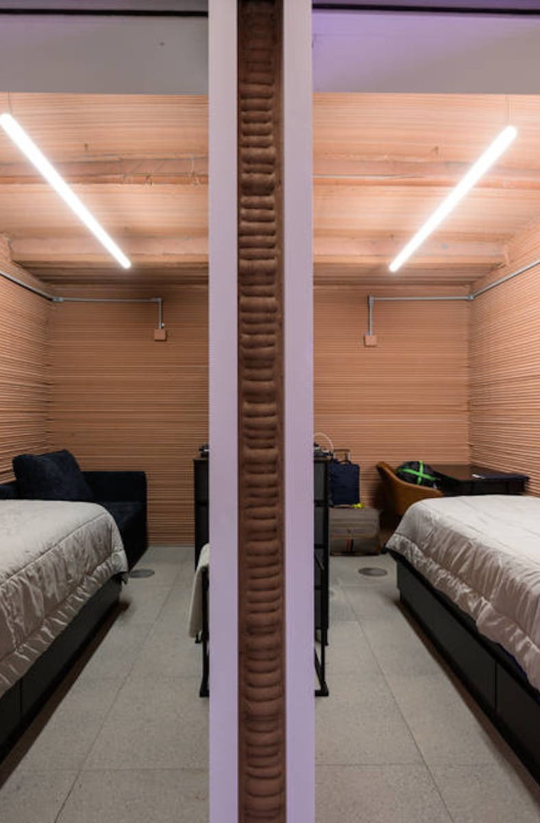 Two single beds in small side-by-side rooms are the living quarters of the CHAPEA volunteers, who wi...