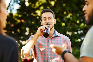 Man drinking beer with friends being vulnerable