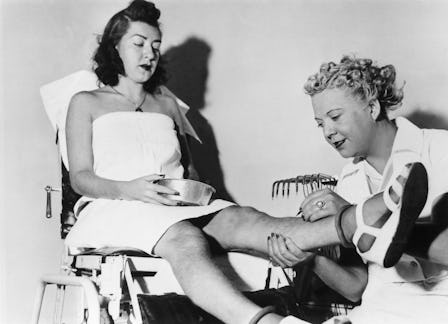A young woman sitting while undergoing hair-removal at the Beatiderm Institute of Electrolysis, with...