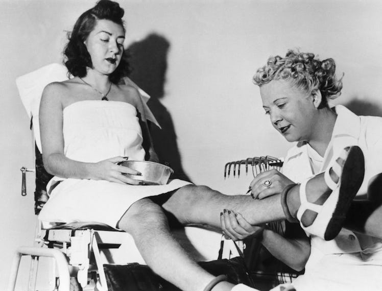 A young woman sitting while undergoing hair-removal at the Beatiderm Institute of Electrolysis, with...