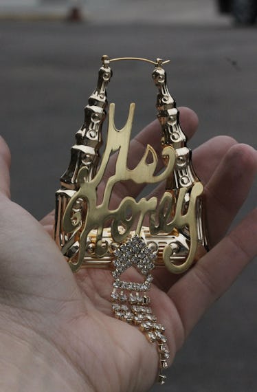 a golden bamboo earring that says ms. honey on it