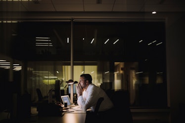 Stressed man working at office late at night
