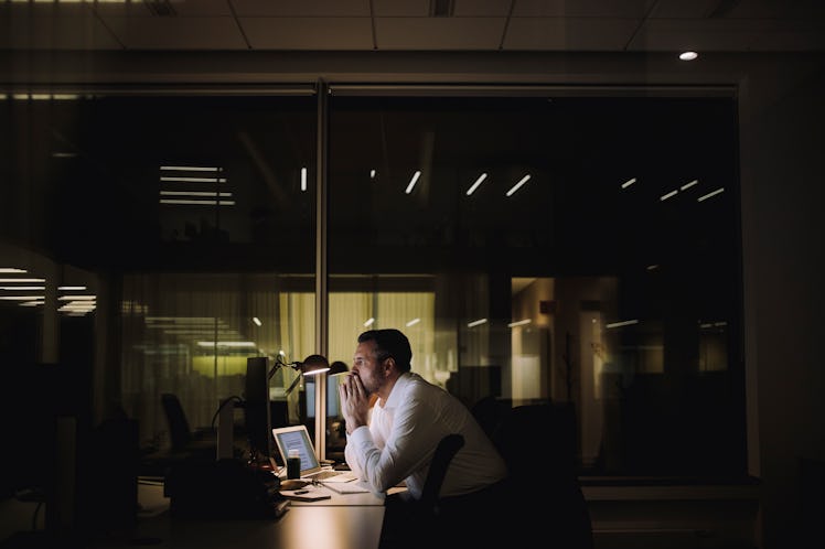 Stressed man working at office late at night 