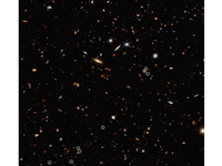This view of the night sky is full of galaxies small and large. Along the middle of the image there ...
