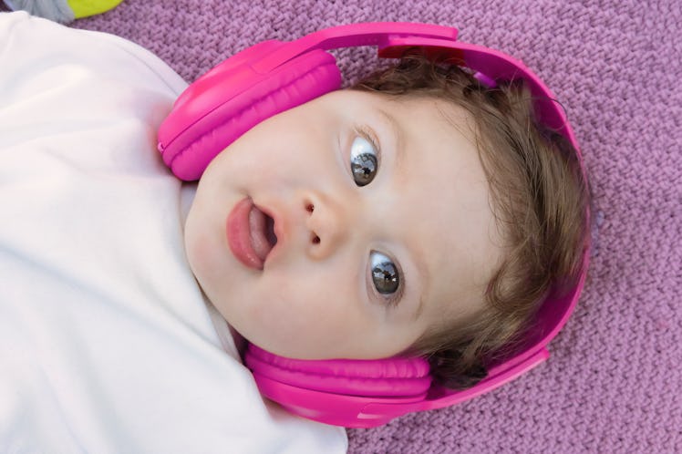 A baby wearing noise-cancelling headphones as ear protection.