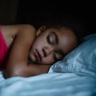 A child sleeping in bed.