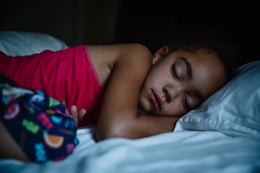 A child sleeping in bed.