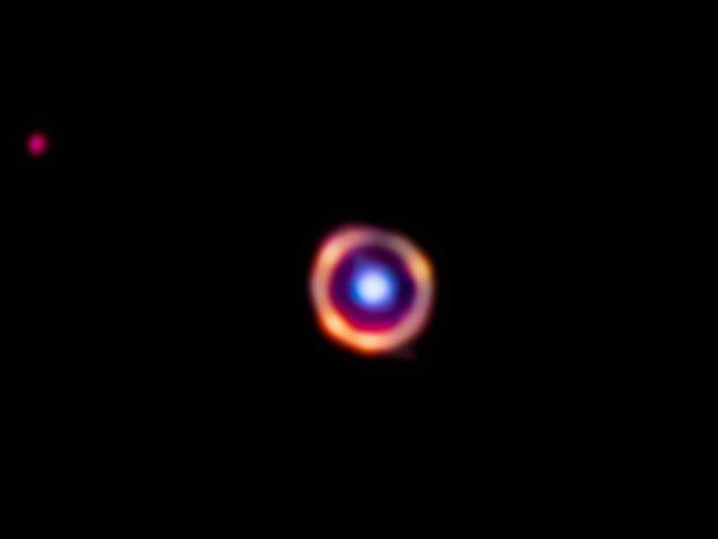 There is a ring with a sphere in the middle. The circle is light from a galaxy from only 1.5 billion...