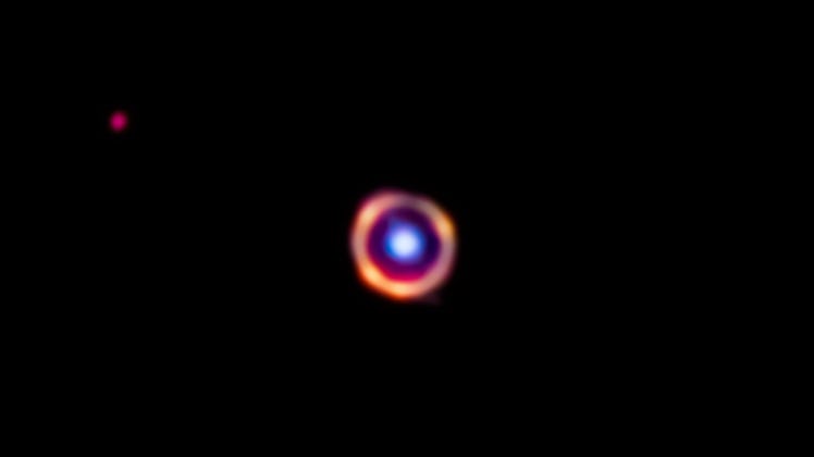 There is a ring with a sphere in the middle. The circle is light from a galaxy from only 1.5 billion...