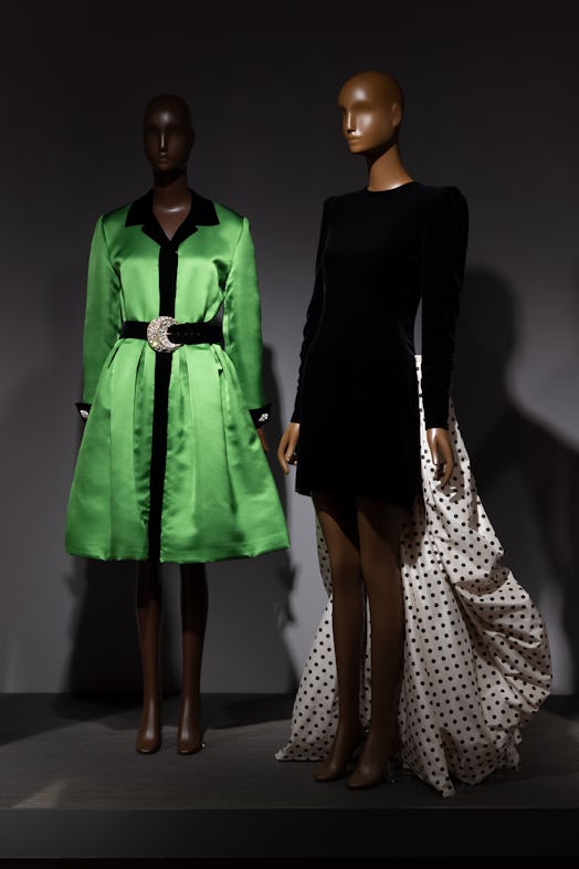 Cocktail dresses by Oscar de la Renta (left) and Carolina Herrera (right) on view in the exhibition ...