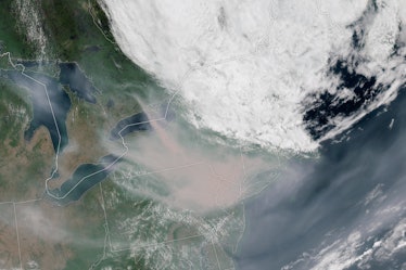 satellite image of a translucent white cloud of smoke over the northeastern U.S., which shows up in ...