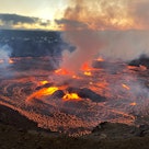 Hawaii's Mount Kilauea, erupting in the morning hours of June 7, 2023. There are red blasts of lava ...
