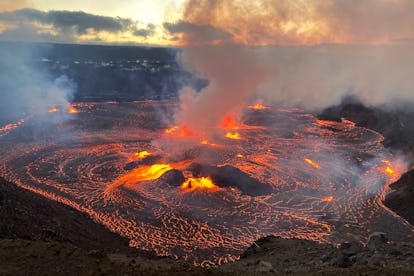 Hawaii's Mount Kilauea, erupting in the morning hours of June 7, 2023. There are red blasts of lava ...