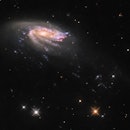 A galaxy appears almost side on, and looks almost like a flying saucer. Its got a glittering disk, a...