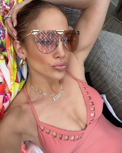 Jennifer Lopez one piece bathing suit and nameplate necklace