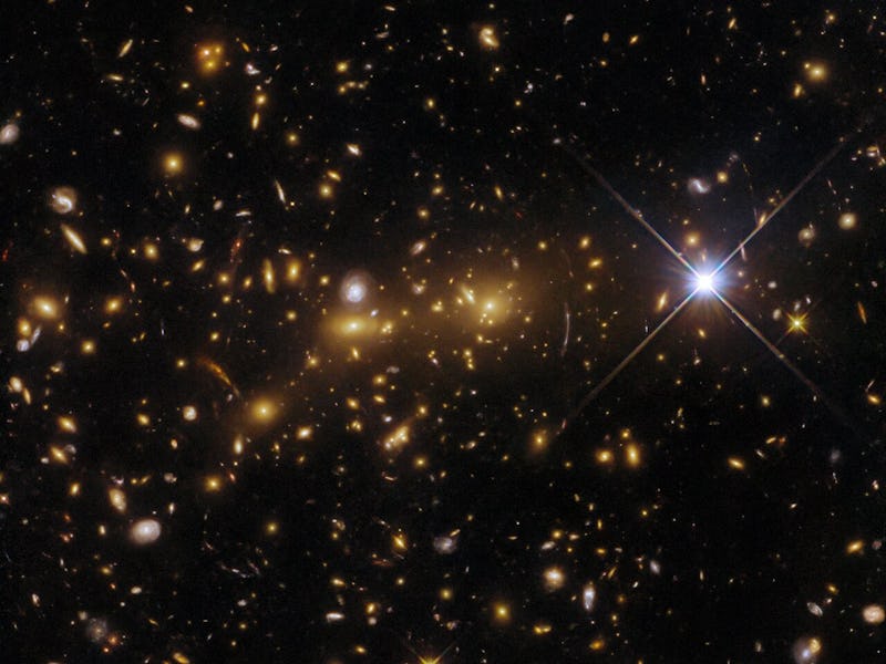 Hubble Space Telescope captured this view of two distant galaxy clusters about to merge. The bright ...