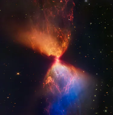 An hourglass shape lights up the sky. At its center is a small disk. The upward and downward funnels...