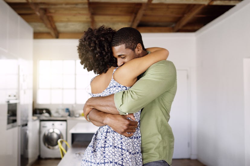 Man and woman embracing in their home