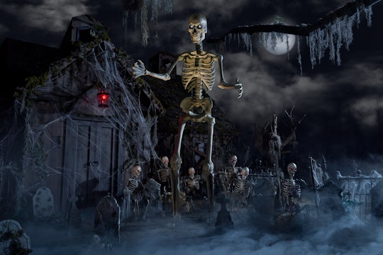 12-foot skeleton from Home Depot stands in graveyard set