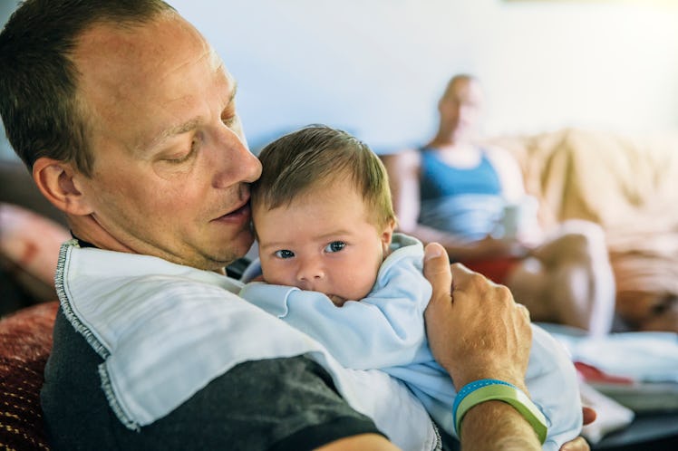 A dad burping his baby.