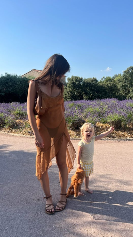 Emily Ratajkowski wears a brown sheer dress and exposed thong in the south of France.