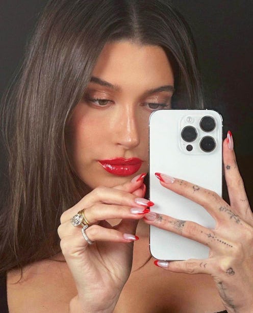 Hailey Bieber's red chrome French tips are just one version of her famous glazed nails.