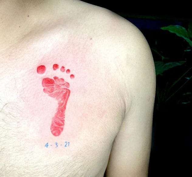 colorful baby footprint tattoo with birthdate