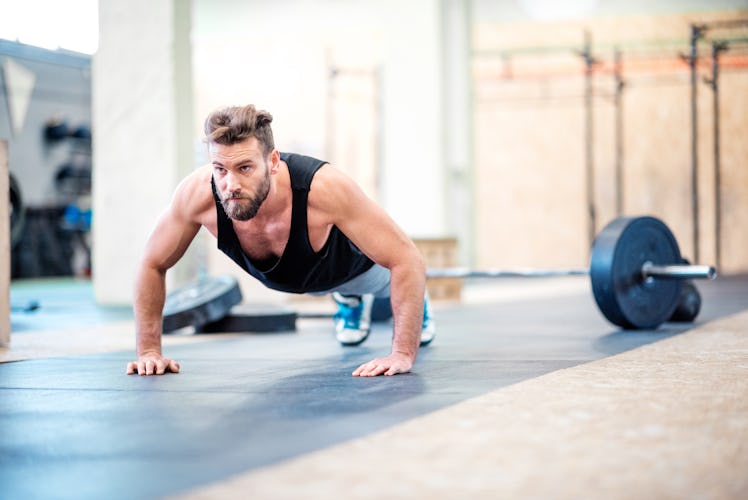 A man doing push-ups at a gym during his push day workout.