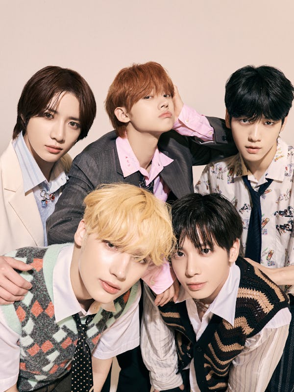 The members of TXT pose for a promotional photo for “Do It Like That."