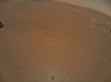 A vast terrain on Mars. The scene looks like a desert, vast and flat with some shallow formations sc...