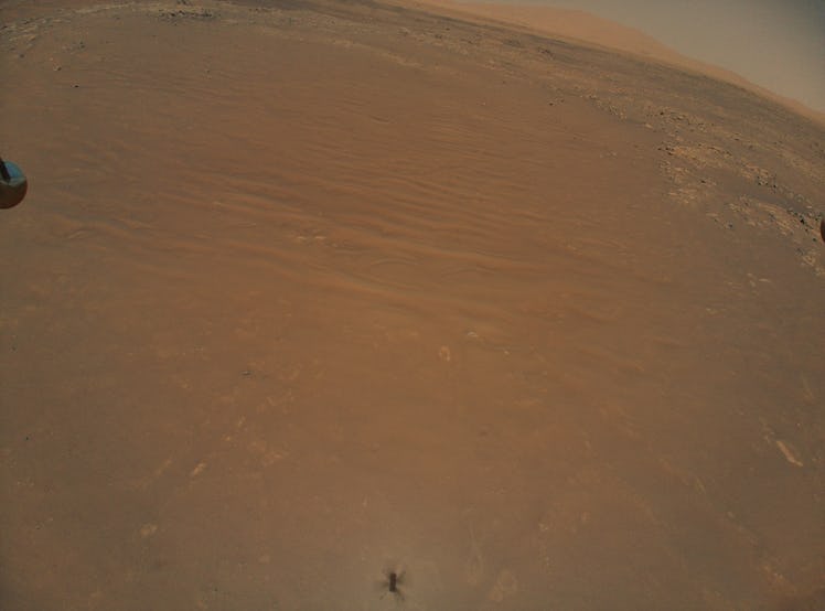 A vast terrain on Mars. The scene looks like a desert, vast and flat with some shallow formations sc...