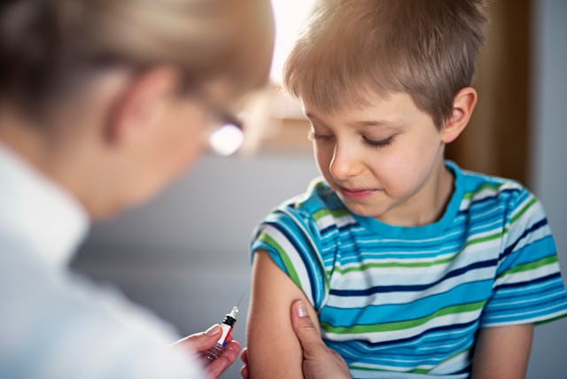 A boy gets his blood drawn at the doctor's office