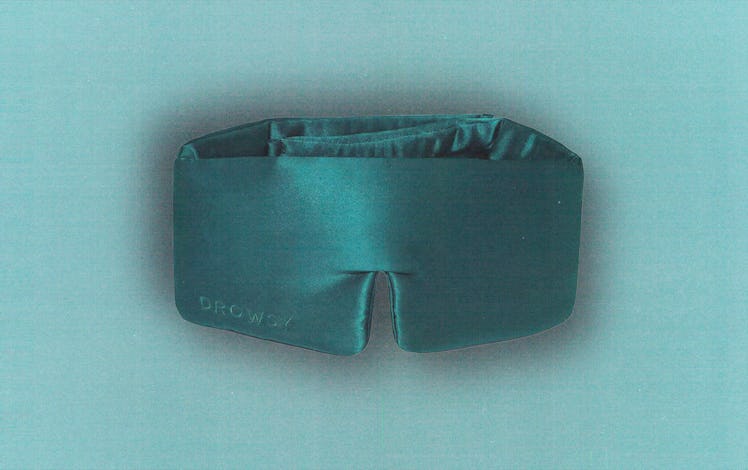 a green silk eye mask against a green background